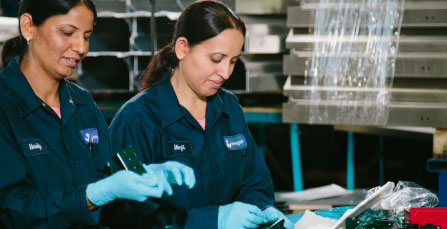 Wesgar footer banner image: Two women inspecting sheet metal products