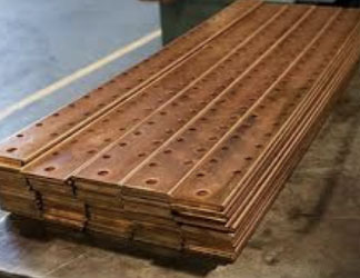 Stacks of copper bus bar with holes drilled